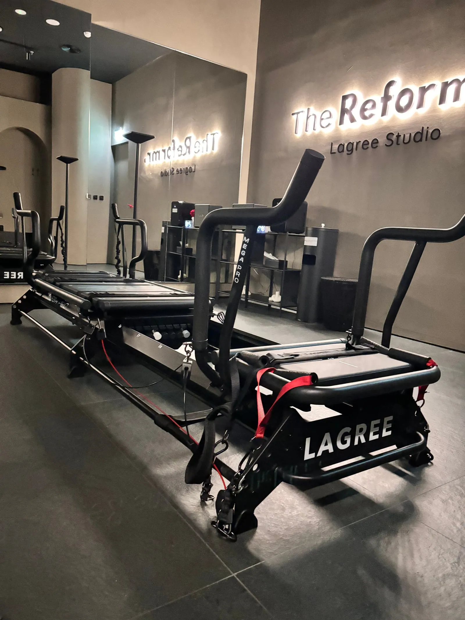 The Reformr. Lagree Studio sign above a black Lagree Megaformer