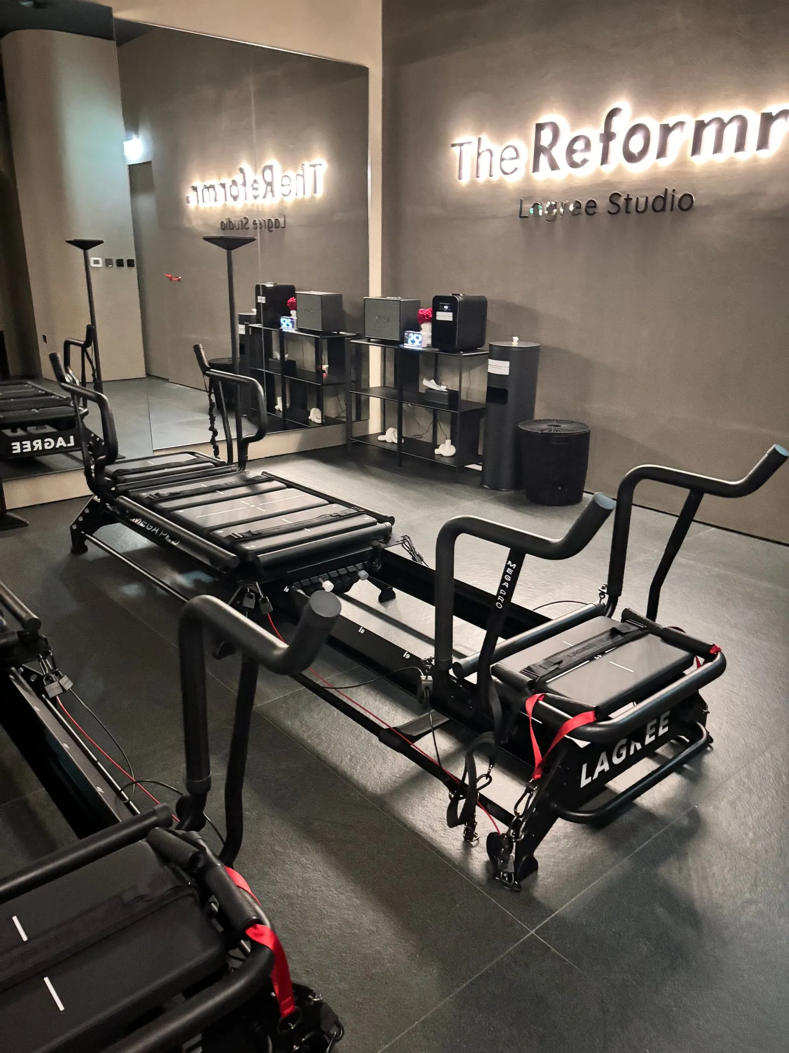 The Reformr. Lagree Studio sign, reception shelves and a Megaformer at Abu Dhabi Mall