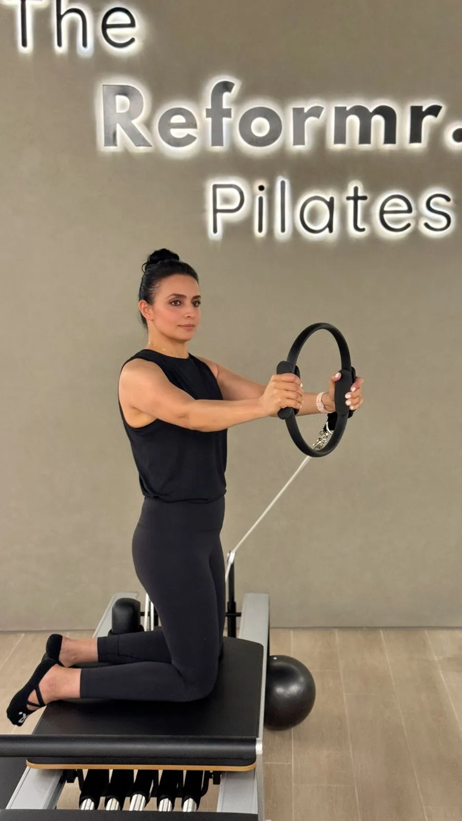 Instructor demonstrating a Pilates ring exercise