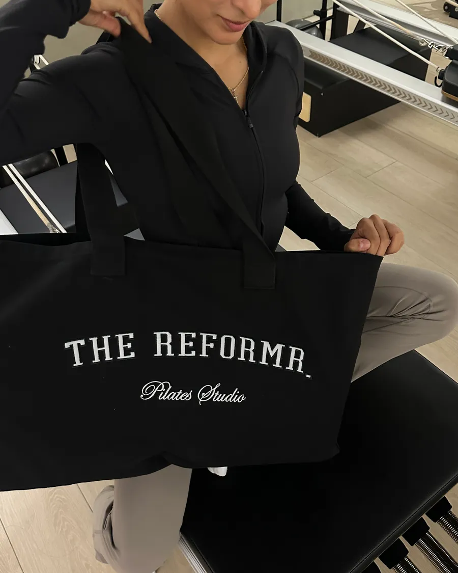 The black Reformr tote bag, one of the membership goodies